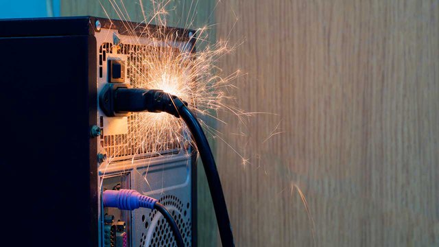 A picture of a sparking socket about to catch to fire; how to put out an electrical fire