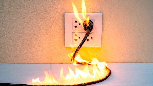 A fire rages on a wire and socket; one must know the best way to put out a fire here